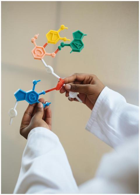 Close-up of a scientist's hands holding a colorful