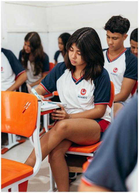 Group of students in school uniforms taking an exa
