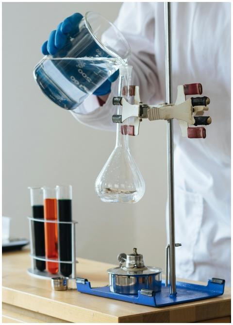 Scientist pouring liquid into a flask in a laborat