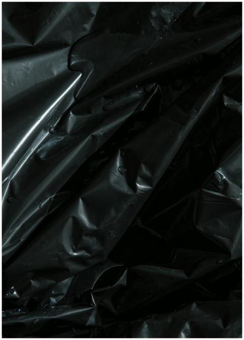 From above of smooth surface of black crumpled pla