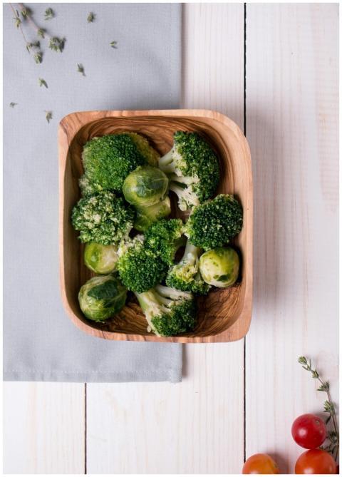 Fresh broccoli and Brussels sprouts in a wooden bo