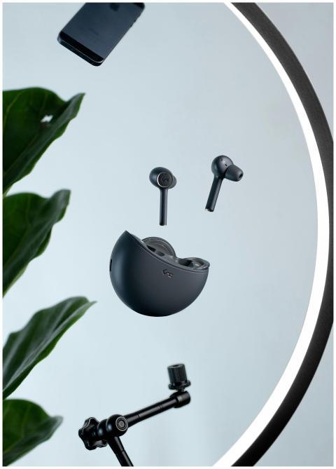 Floating wireless earbuds with charging case on a