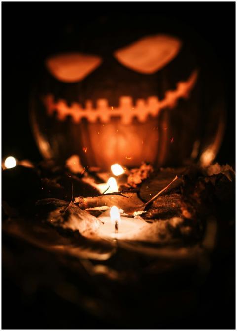 Creepy jack-o'-lantern glowing with candlelight am