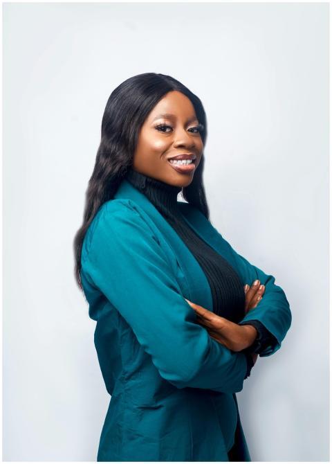 Businesswoman smiling in blue suit with arms cross