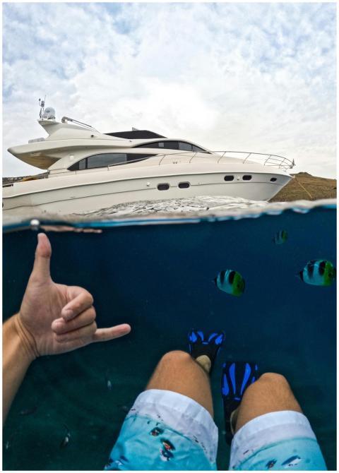 Unique perspective of snorkeling near a luxury yac