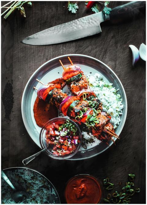 Delicious grilled skewers with rice and salsa serv