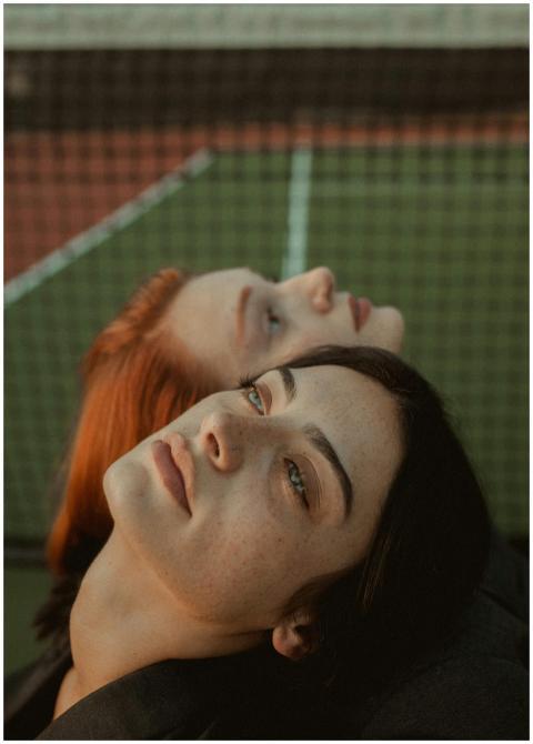Close-up portrait of two women resting on a tennis