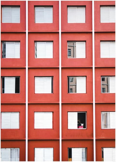 Geometric facade of a red apartment building with