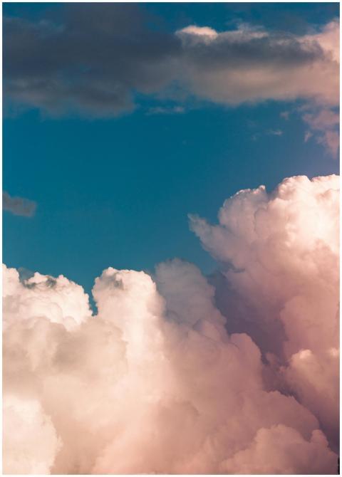 Stunning cumulus clouds fill the sky, offering a d