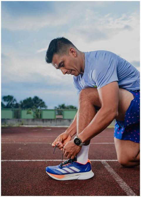 Athlete tying shoe on a Rioja, Perú track, ready f