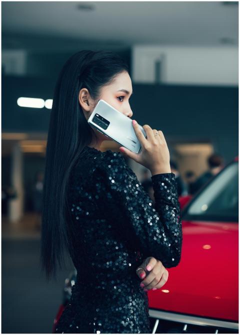 Stylish woman wearing black sequined dress, holdin