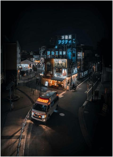 Street view of Tokyo at night featuring a neon-lit