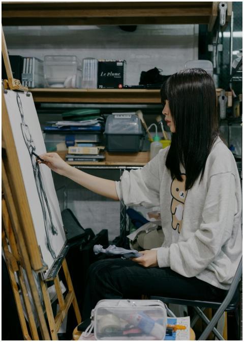 Young artist sketching a figure in a Shinjuku atel
