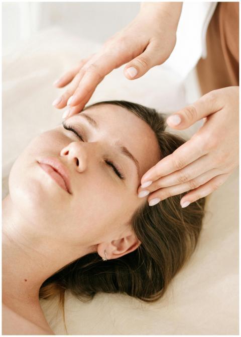 Woman receiving a soothing facial massage in a rel