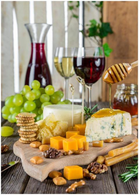 Sophisticated cheese platter with assorted wines,