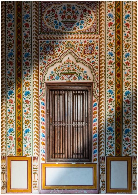 Decorative wooden doorway with colorful floral pat
