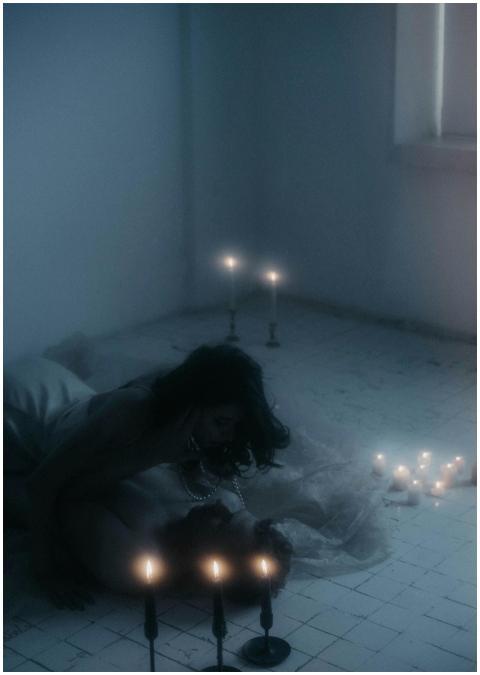 A couple embracing on a dimly lit floor surrounded