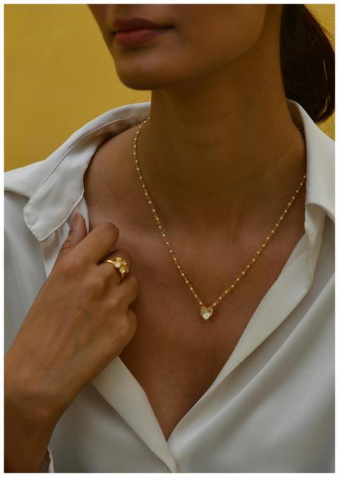 Close-up of a woman displaying a heart-shaped pend
