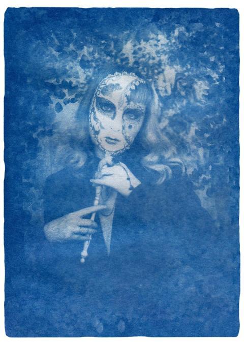 Artistic cyanotype of a woman in a mask, creating