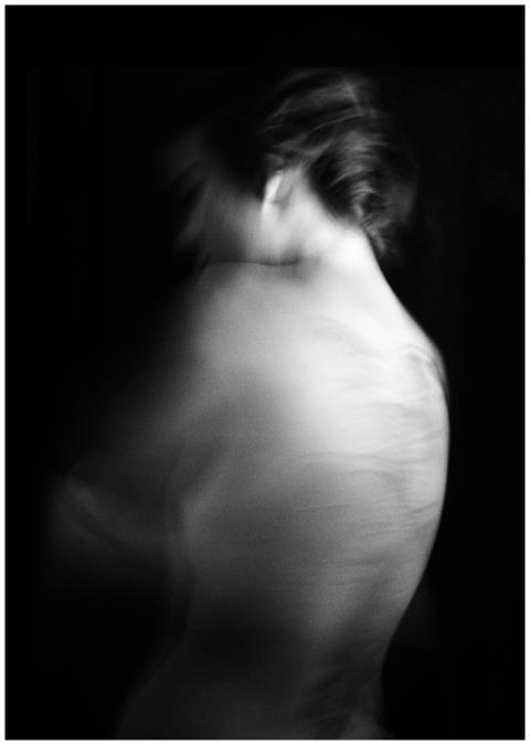 Ethereal black and white image of a blurred human