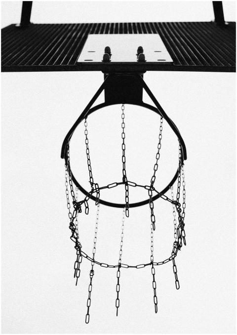 Black and white view of a chain link basketball ho