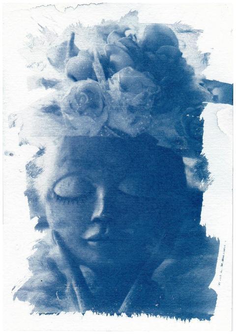 Cyanotype image of a serene doll with closed eyes