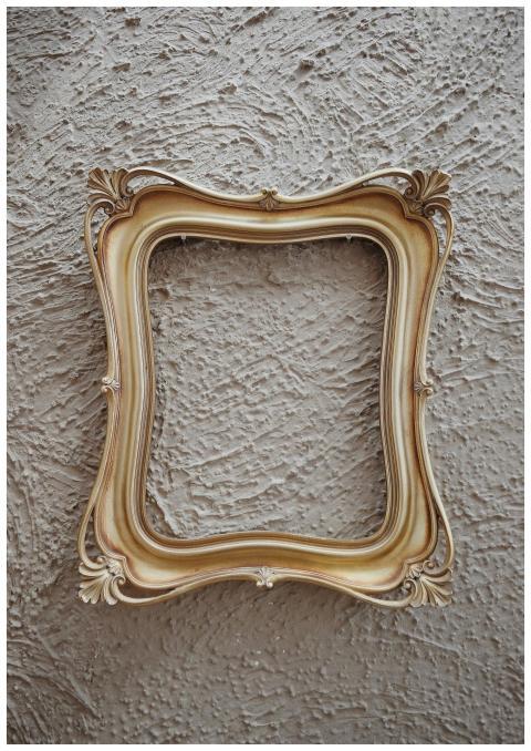 Antique golden frame with ornate details against a