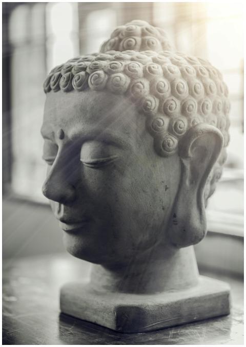 Calm Buddha sculpture gracefully lit by sunlight r