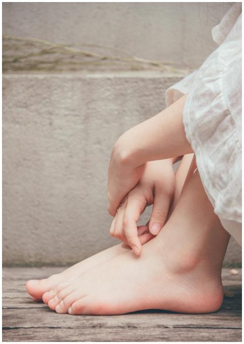 Elegant close-up of a woman's bare feet and hands