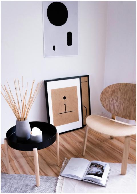 A modern, minimalist room showcasing art, a chair,