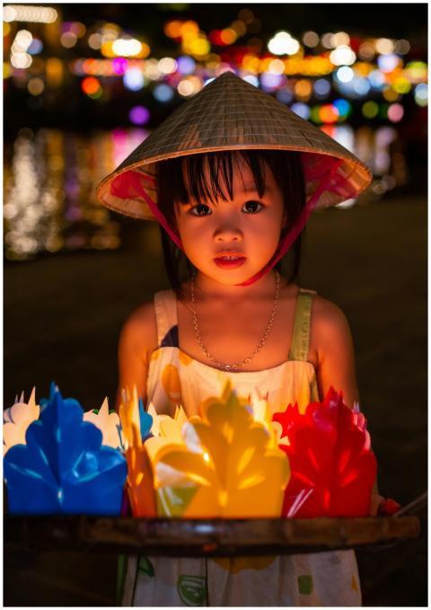 Captivating night portrait of a child holding colo