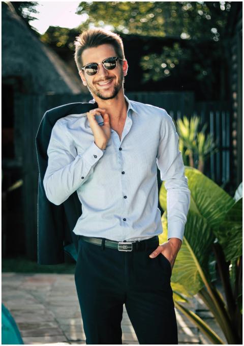 Confident young man in a stylish suit outdoors, ex