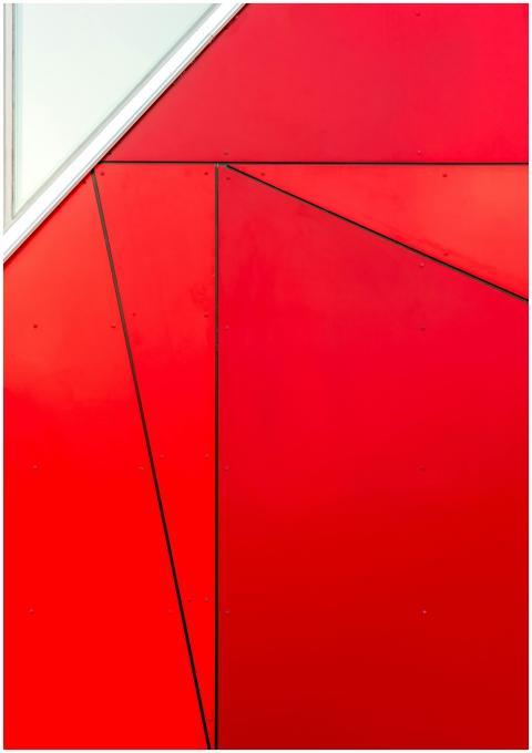 Abstract red geometric facade with triangular patt