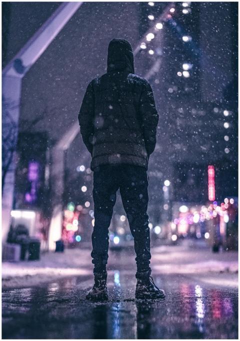 A person stands on a snow-covered street in Montre