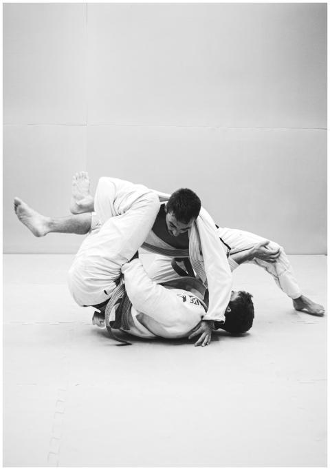 Two men practicing Brazilian Jiu-Jitsu, showcasing