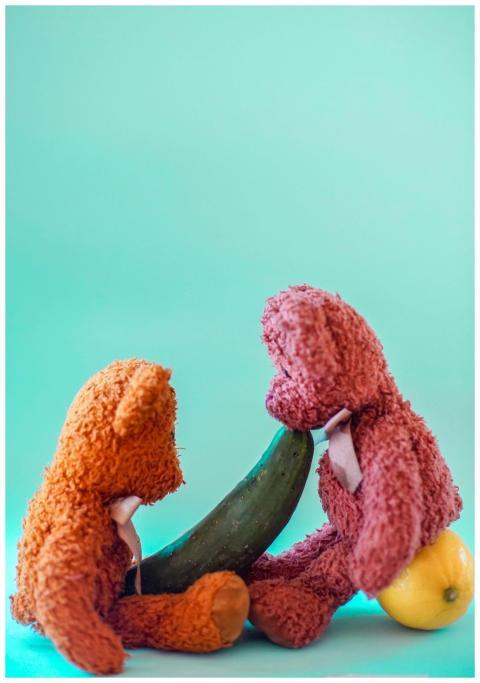 Two colorful teddy bears interacting creatively wi