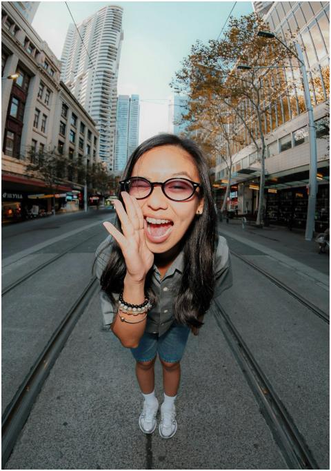 A cheerful young woman on a bustling street in Syd
