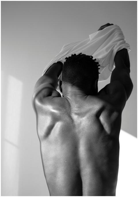 Grayscale image of a shirtless muscular man from b