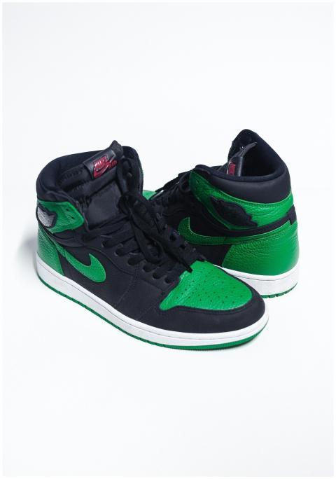 Stylish black and green sneakers with a sleek desi