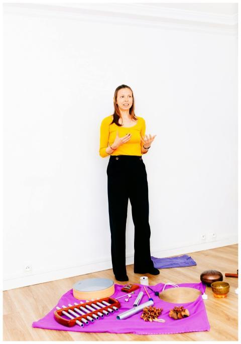 Woman standing by various instruments in a bright