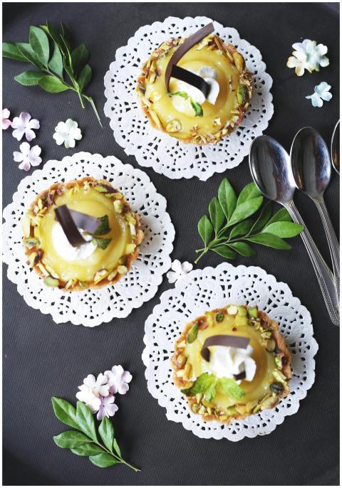 Top view of lemon tarts adorned with whipped cream