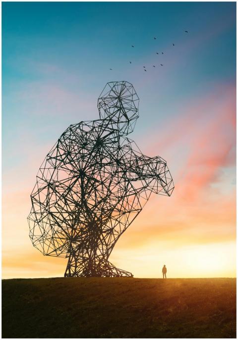 A towering abstract wire sculpture during a colorf
