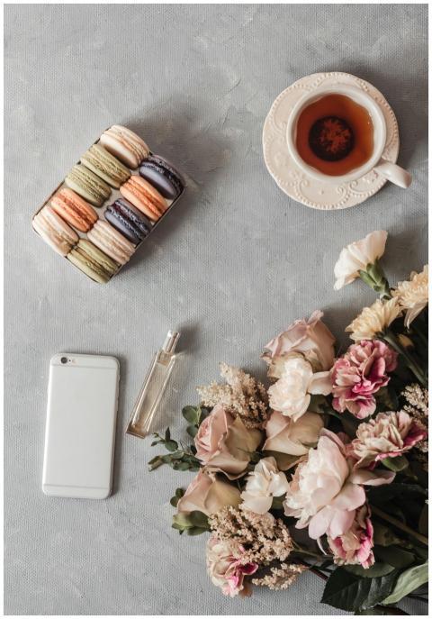 Chic flatlay featuring a bouquet, cup of tea, maca
