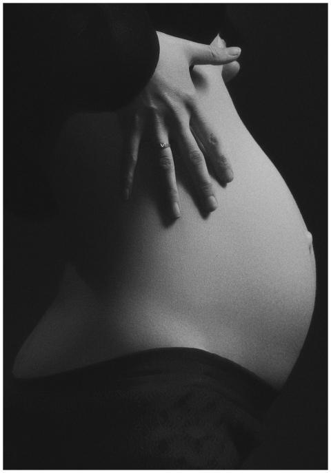 Intimate black and white photo of a pregnant woman