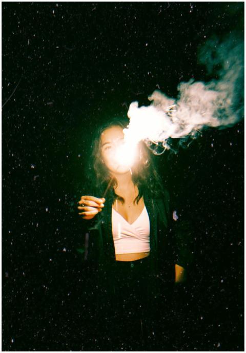 Positive young female in casual wear with burning