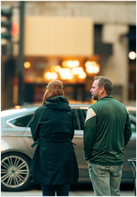 Two adults engaged in conversation on a busy Chica