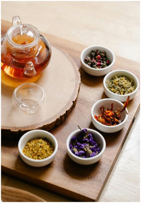 Glass teapot with herbal tea and assorted dry herb