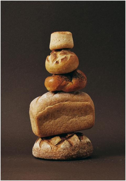 Stack of various bread loaves artfully arranged ag