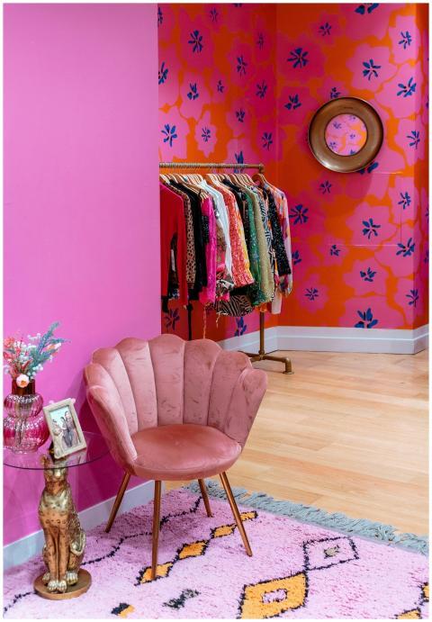 Colorful room with pink armchair and clothing rack