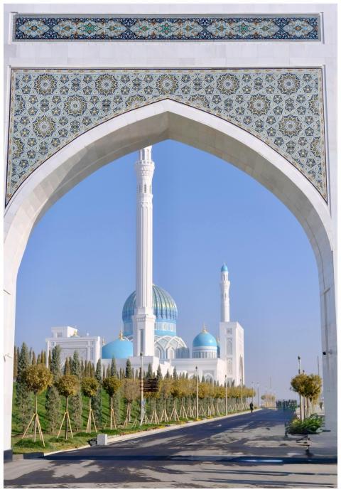 Ornate archway beautifully frames a stunning mosqu